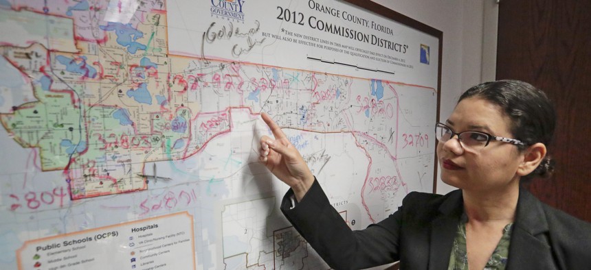 County Commissioner Emily Bonilla of Orange County, Florida, shows a map of her district. The Democrat fears an undercount in this year’s census. Florida is among the red states now pushing to boost participation.