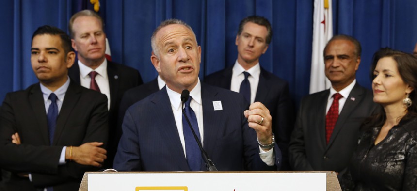 In this March 20, 2019 file photo, Sacramento Mayor Darrell Steinberg, center, head of the BIG City Mayors, discusses the homeless problem after the group met with Gov. Gavin Newsom, fourth from right, in Sacramento, Calif. 