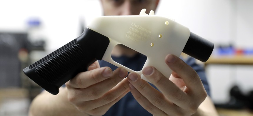 Cody Wilson, formerly with Defense Distributed, holds a 3D-printed gun called the Liberator.