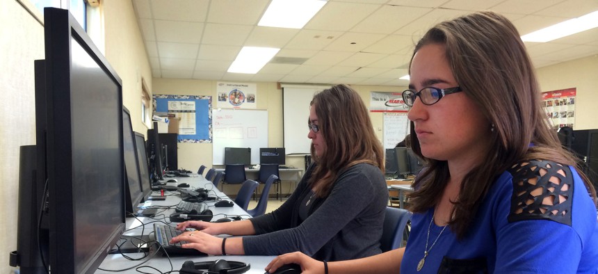 In this April 30, 2015 photo, Sylvia Fonseca, 16, works in the computer lab at Cuyama Valley High School in California. The school district has internet connections about one-tenth the minimum speed recommended for the modern U.S. classroom.