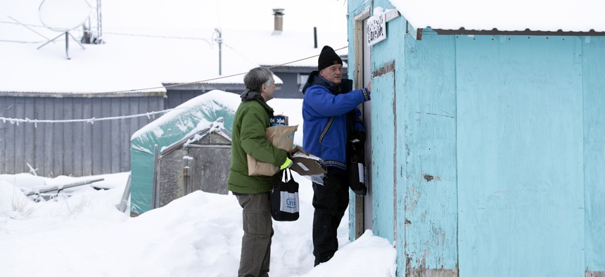 Census bureau director Steven Dillingham, right, knocks on the door alongside Census worker Tim Metzger as they arrive to conduct the first enumeration of the 2020 Census Tuesday, Jan. 21, 2020, in Toksook Bay, Alaska.