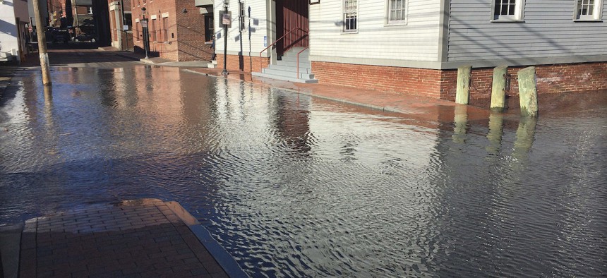 High tide floods a street Friday, Nov. 18, 2016, in Portland, Maine