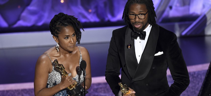 Karen Rupert Toliver, left, and Matthew A. Cherry accept the award for best animated short film for "Hair Love" at the Oscars.
