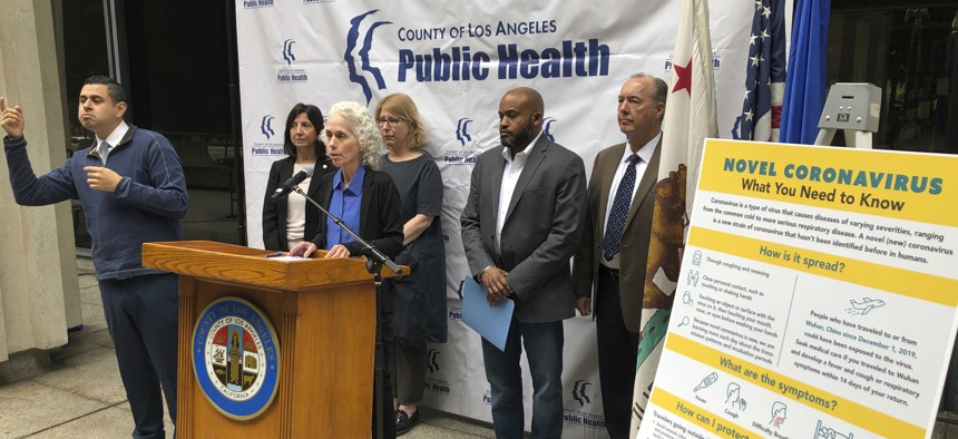 Dr. Sharon Balter, at the podium with Los Angeles County Department of Public Health officials, talks about a patient taken to a hospital with coronavirus symptoms at a news conference in Los Angeles on Jan. 26, 2020. 