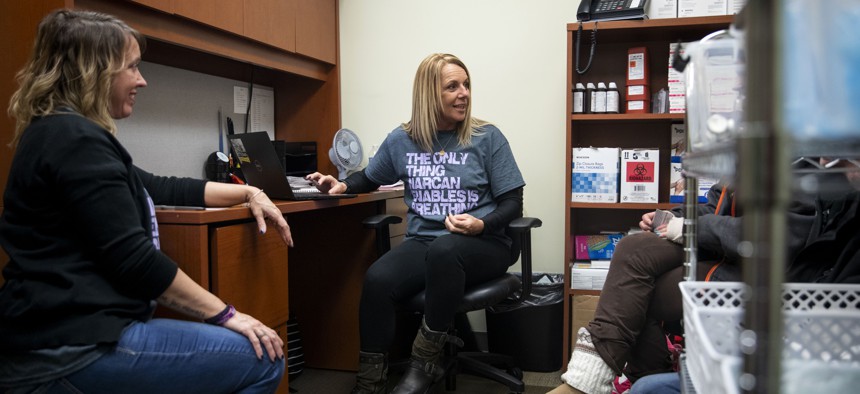 Charmin Gabbard (center) and Darci Moore (left) gather information from two participants at the syringe exchange run by Fayette County Harm Reduction Alliance in Connersville, Indiana, on Jan. 23, 2020. The exchange had reopened the day before. 