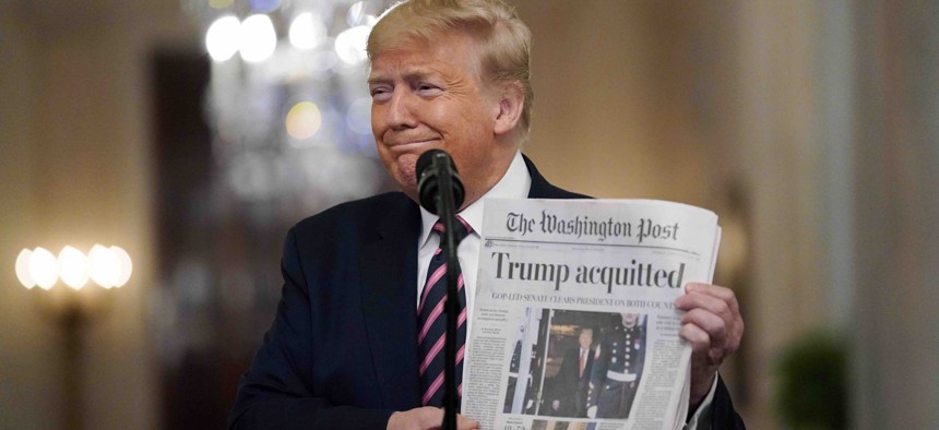 President Donald Trump holds a copy of The Washington Post as he speaks in the East Room of the White House, Thursday, Feb. 6, 2020, in Washington. Trump has described the news outlet and others as "fake news" during the course of his presidency.