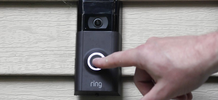In this Tuesday, July 16, 2019, file photo, Ernie Field pushes the doorbell on his Ring doorbell camera at his home in Wolcott, Conn.