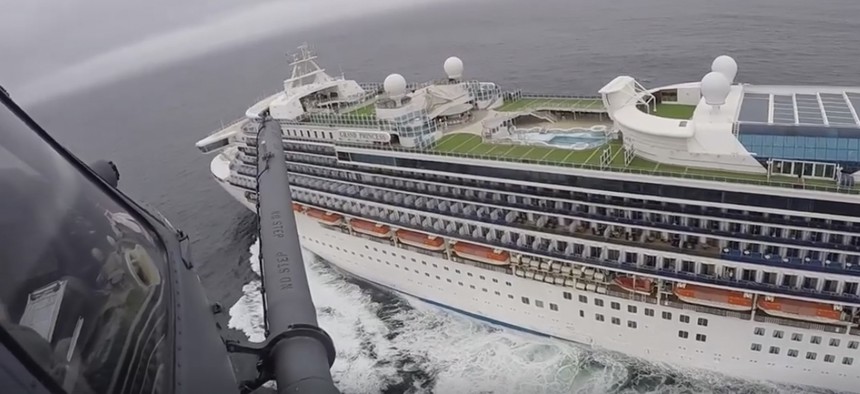 In this image from video, provided by the California National Guard, a helicopter carrying airmen with the 129th Rescue Wing flies over the Grand Princess cruise ship off the coast of California Thursday, March 5, 2020. 