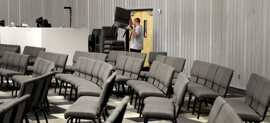 Grace Bible Church facilities manager Kenny Sitton rearranges the seating for greater distance between seats on March 13, 2020, in Tempe, Ariz. after a state-wide conference call with Arizona Disease Control about preventing spread of Covid-19.