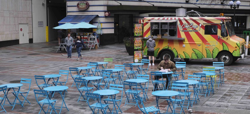 A nearly empty dining area near where food trucks park at a downtown park is pictured, Wednesday, March 11, 2020, in Seattle. 