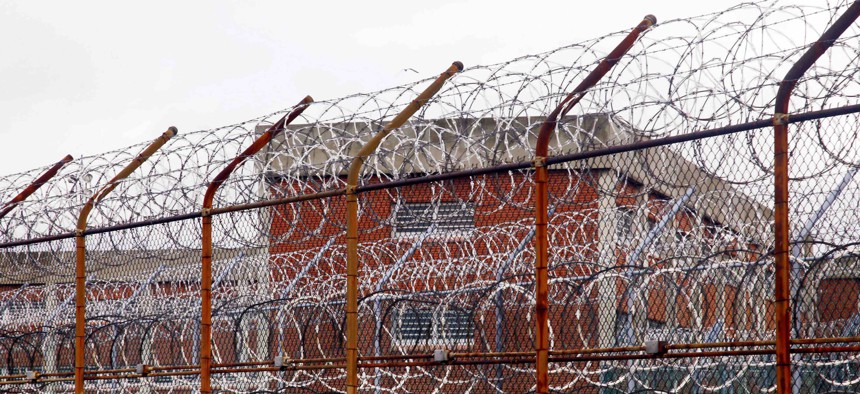 In this 2011, file photo, a fence surrounds housing on the Rikers Island correctional facility in New York. The city's jail system has cases of the coronavirus. Neighboring New Jersey is moving ahead with an inmate release plan.