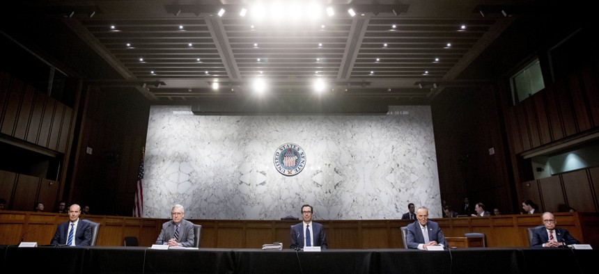 From left, Labor Secretary Eugene Scalia, Senate Majority Leader Mitch McConnell of Ky., Treasury Secretary Steven Mnuchin, Senate Minority Leader Sen. Chuck Schumer of N.Y., and others attend a meeting to discuss the coronavirus relief bill.