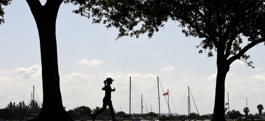 A runner makes her way along the Davis Islands Yacht Basin on a beautiful spring day, Wednesday, March 25, 2020, in Tampa, Fla. 