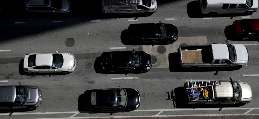 In this July 2, 2019, file photo vehicles wait for a green light in downtown Baltimore.