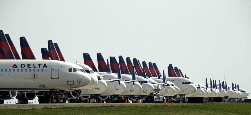 Mothballed Delta Air Lines jets are parked at Kansas City International Airport Wednesday, April 1, 2020 in Kansas City, Mo. Air travel has plummeted as the nation fights the coronavirus. That's raising budget concerns for communities near airports.