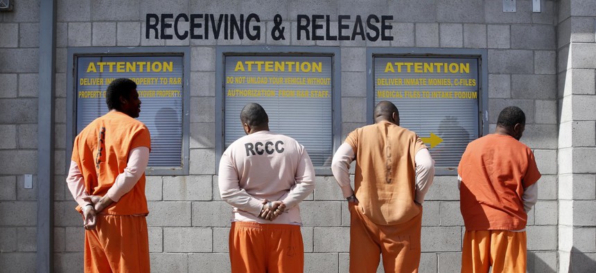 People wait to be processed in a California correctional facility. California changed its bail schedule with the intention of releasing more people from jails and slowing the spread of coronavirus in correctional facilities.