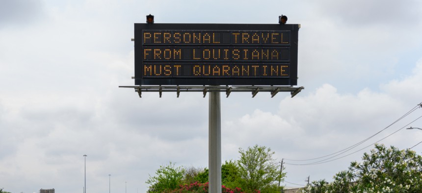 A sign in Texas orders out-of-state visitors to quarantine for two weeks.