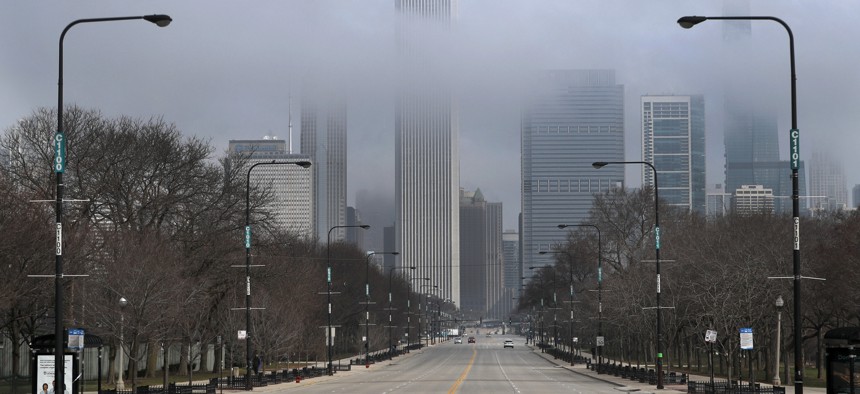 Fog lifts over Chicago and the usually busy Columbus Drive after people were ordered to stay at home. Illinois Gov. JB Pritzker's office estimates the budget shortfall for 2021 will top $6 billion because of the coronavirus-fueled economic downturn.  