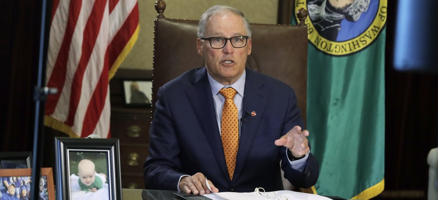 Washington Gov. Jay Inslee sits at his desk and rehearses a speech Tuesday, April 21, 2020, at the Capitol in Olympia, Wash., minutes before going live to address the public on the state's next steps in addressing the coronavirus outbreak.