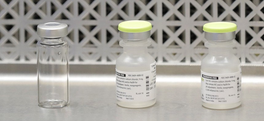A file photo shows vials used by pharmacists to prepare syringes used on the first day of a first-stage safety study clinical trial of the potential vaccine for COVID-19 at the Kaiser Permanente Washington Health Research Institute in Seattle. 