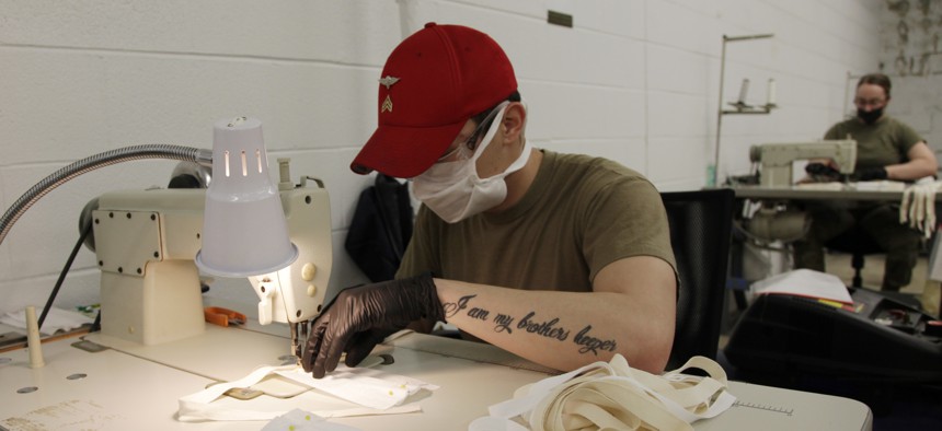 A U.S. Army paratrooper assigned to the 347th Quartermaster Company sews together a cloth face mask at Fort Bragg, N.C. Parachute riggers are constructing PPE, while continuing to support Fort Bragg's ongoing Airborne operations.