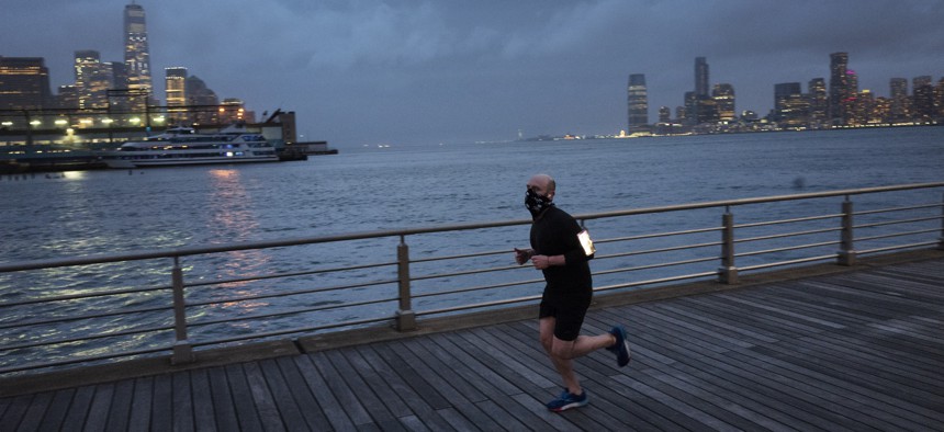 A jogger wears a face mask in New York’s Hudson River Park last month. Many Americans who used to manage their anxiety with exercise are now finding that doesn’t cut it under the stress and the isolation of the coronavirus epidemic.
