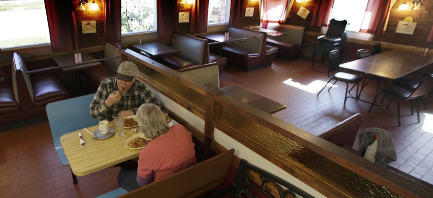 Customers Randy and Nancy Cree eat dinner in the dining room of the Chic-A-Dee Cafe In Topeka, Kan., Tuesday, May 5, 2020. Some booths are closed in order to maintain distance. 