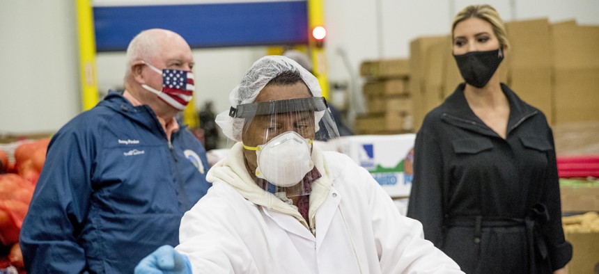 Ivanka Trump, the daughter of President Donald Trump, right, and Agriculture Secretary Sonny Perdue, left, tour Coastal Sunbelt Produce on May 15, 2020, in Laurel, Md. 