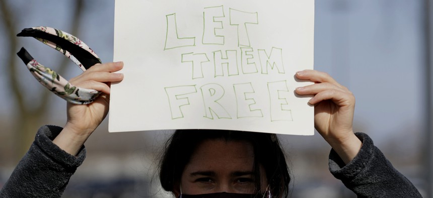 A woman protests outside Cook County Jail in Chicago, asking for the release of detainees during the pandemic.