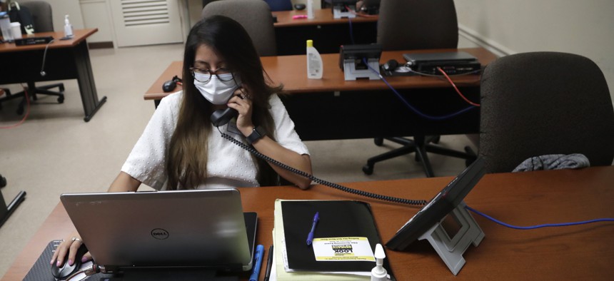 A contact tracer running down contacts of coronavirus patients at the Florida Department of Health in Miami-Dade County.