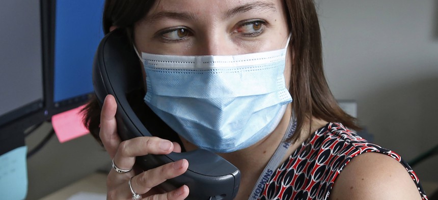A health investigator in Salt Lake County, Utah works the phones in this May 19 photograph. States and local governments around the U.S. are looking to expand coronavirus contact tracing programs.
