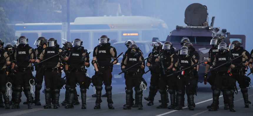 Police in riot gear prepare to advance on protesters, Saturday, May 30, 2020, in Minneapolis. Protests continued following the death of George Floyd, who died after being restrained by Minneapolis police officers on Memorial Day.