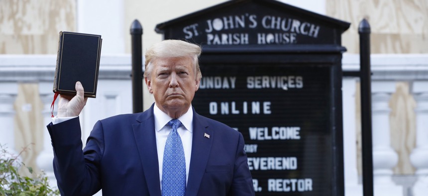 President Donald Trump holds a Bible as he visits outside St. John's Church from the White House on June 1, 2020, in Washington. Trump walked to the church after a Rose Garden speech and police clearing of protesters from outside the White House. 