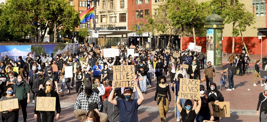Demonstrators march in San Francisco on Sunday, May 31, 2020, protesting the death of George Floyd, who died after being restrained by Minneapolis police officers on May 25.