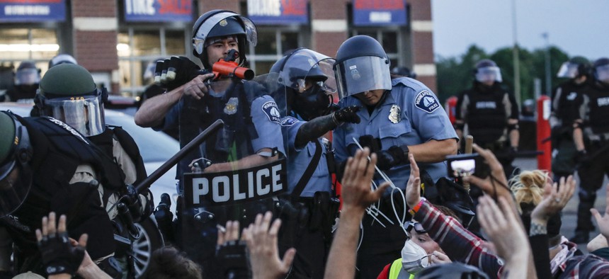 Members of the Minneapolis police arrest protesters on May 31, 2020.