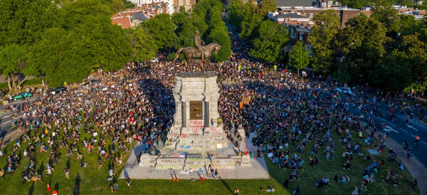 In this photo taken with a drone, a large group of protesters gather around the statue of Confederate General Robert E. Lee on Monument Avenue near downtown on June 2, 2020, in Richmond, Va. The crowd protesting police brutality chanted "Tear it down."