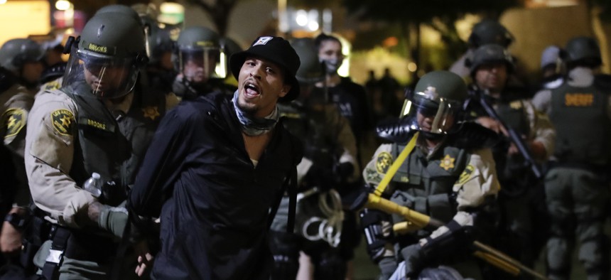 Demonstrators are arrested for a curfew violation Wednesday, June 3, 2020 in downtown Los Angeles during a protest over the death of George Floyd who died May 25 after he was restrained by Minneapolis police.