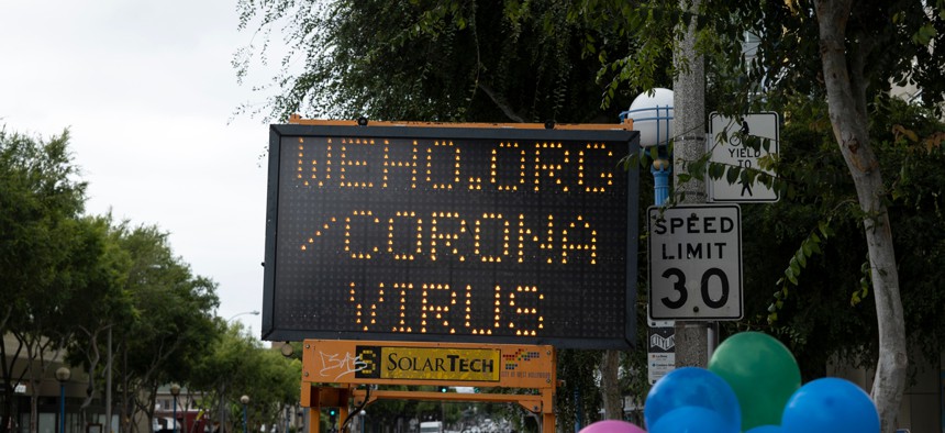 A sign in West Hollywood, California encourages residents to learn more about the local coronavirus fight.
