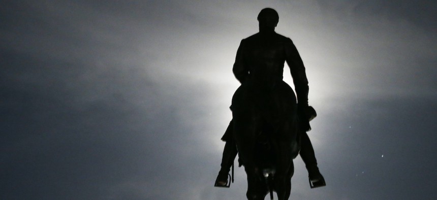 The moon illuminates the statue of Confederate General Robert E. Lee on Monument Avenue in Richmond, Va. Virginia Gov. Ralph Northam has ordered the removal of the statue.