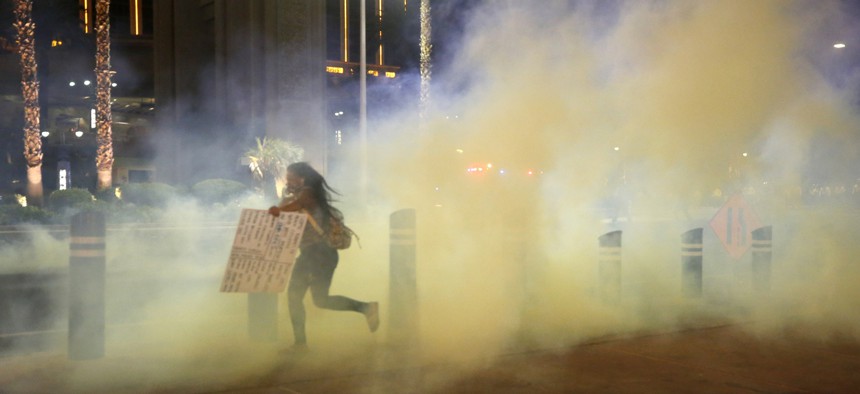 A protester runs from tear gas in Las Vegas.