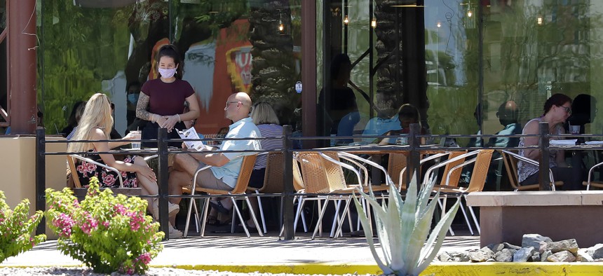 Guests dine in-house at a restaurant on May 13, 2020, in Phoenix. 