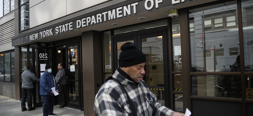 In this March 18, 2020 file photo, visitors to the Department of Labor are turned away at the door by personnel due to closures over coronavirus concerns in New York.