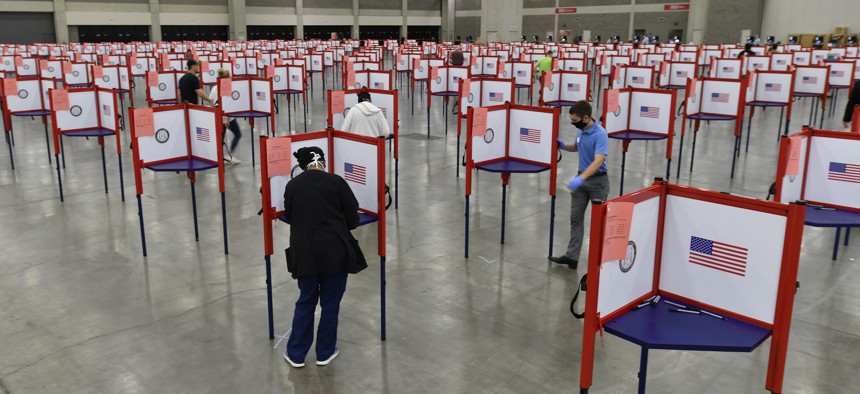 Voting stations are set up in the South Wing of the Kentucky Exposition Center for voters to cast their ballot in the Kentucky primary in Louisville, Ky., Tuesday, June 23, 2020.