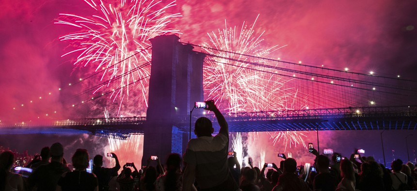 People on the east side of Manhattan watch a fireworks display, part of Independence Day festivities, Thursday, July 4, 2019, in New York. 