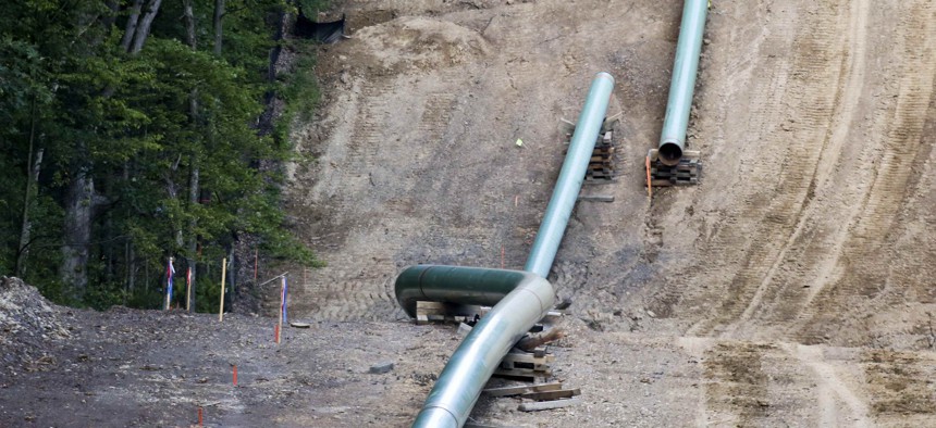 Segments of assembled pipe are lined up along a cleared section of woods where a pipeline for shale gas was under construction during 2017 in Jackson Township, Pa. A new pipeline project in the region has led to controversy.