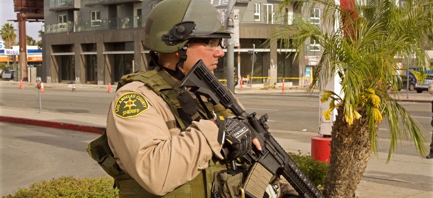 A Los Angeles County police officer holds a rifle at a recent protest.
