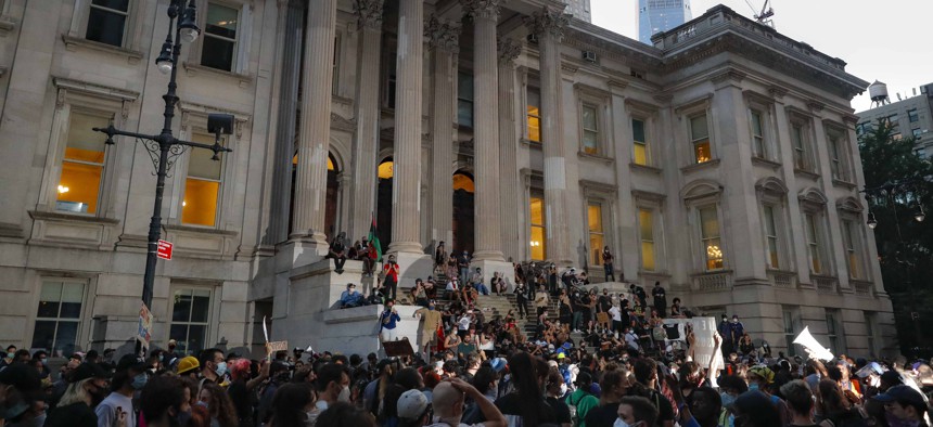 Protestors gather outside City Hall in New York City on June 30, 2020 during lawmakers debate over the police budget.  
