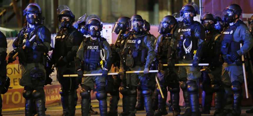 Police in riot gear prepare to disperse a group of protesters as they march through downtown for a third night of unrest on May 31, 2020, in Richmond, Va.