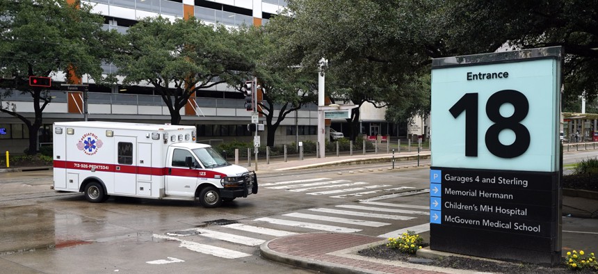 An ambulance drives through the Texas Medical Center on June 25, 2020, in Houston. 