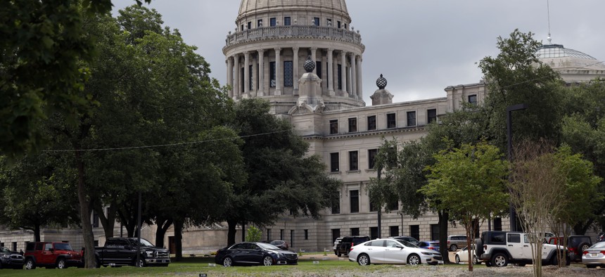 In this July 6, 2020 photo, Mississippi legislators, staff and Capitol employees take advantage of a drive-thru COVID-19 testing center on the Capitol grounds in Jackson, Miss. 